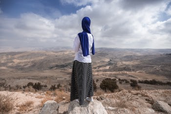 Woman Standing Near Beige Cliff