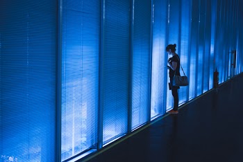 Woman Standing Near Blue Led Wall