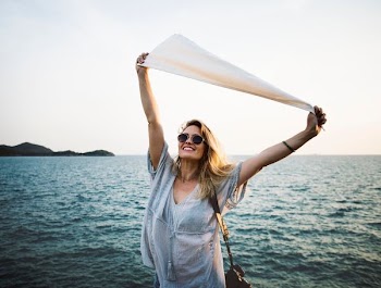 woman standing near body of water