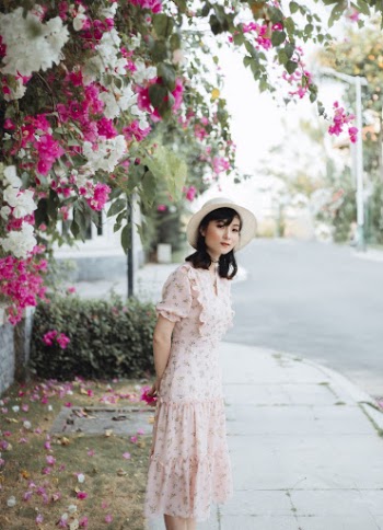 Woman Standing Near Bougainvillea