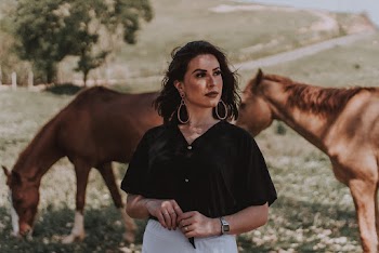 Woman Standing Near Brown Horse