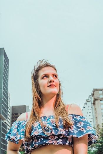 Woman Standing Near Building Under Clear Sky