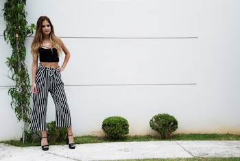 Woman Standing Near Bushes and Wall