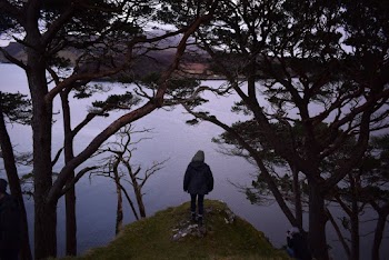 Woman Standing Near Calm Body of Water