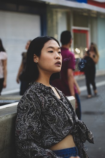 Woman Standing Near Concrete Building