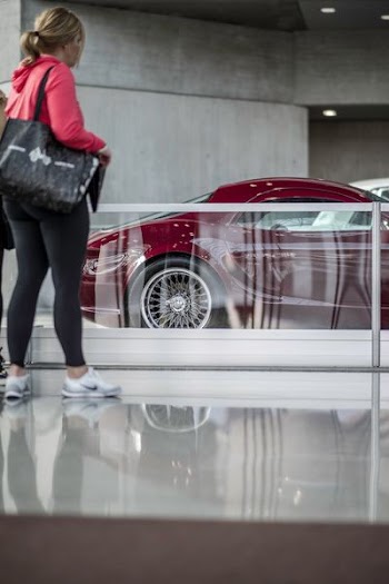 woman standing near coupe car during daytime