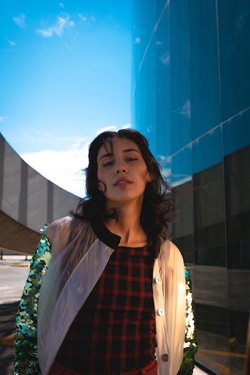 Woman Standing Near Curtain Building
