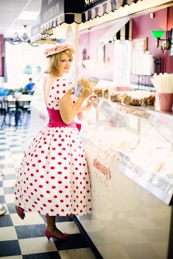 Woman Standing Near Display Counter Inside Establishment
