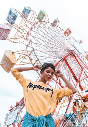 woman standing near ferris wheel
