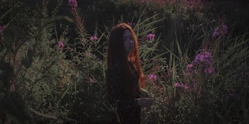 Woman Standing Near Flowering Plants