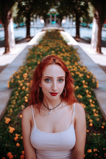 Woman Standing Near Flowers