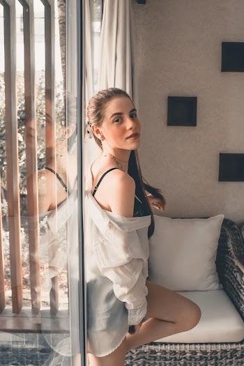 Woman Standing Near Glass Wall