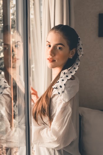 Woman Standing Near Glass Wall
