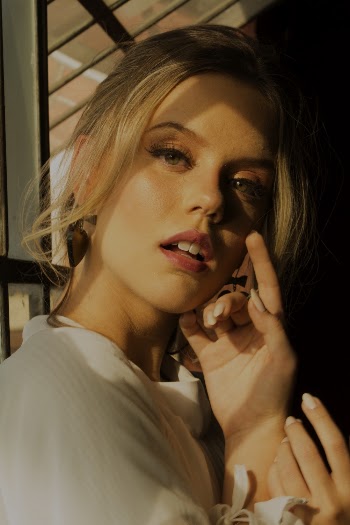 Woman Standing Near Glass Window
