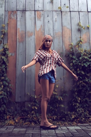Woman Standing Near Gray and Brown Wooden Wall