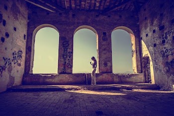 woman standing near gray concrete window
