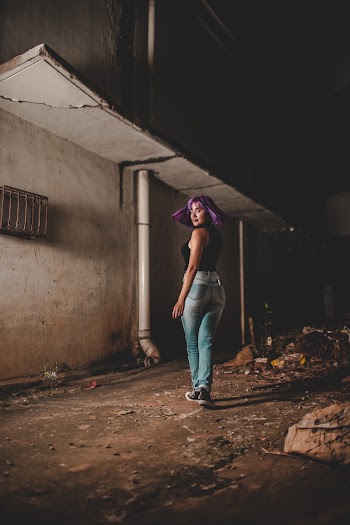 Woman Standing Near Gray House