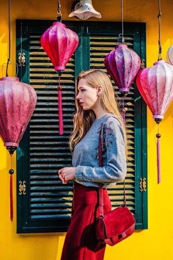 woman standing near green louver door