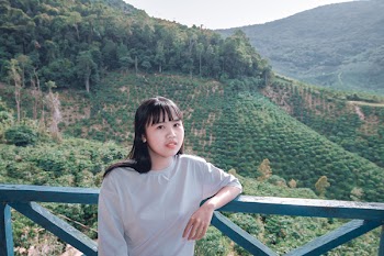 Woman Standing Near Green Mountain