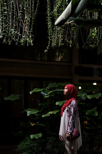 Woman Standing Near Green Plants