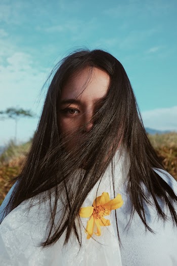 Woman Standing Near Green Plants