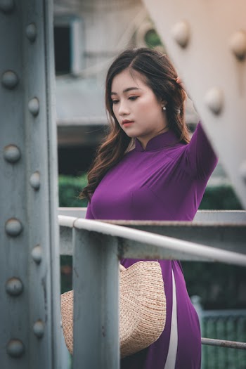 Woman Standing Near Grey Metal Railings