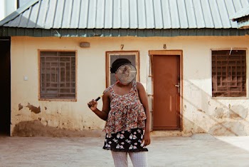 Woman Standing Near House