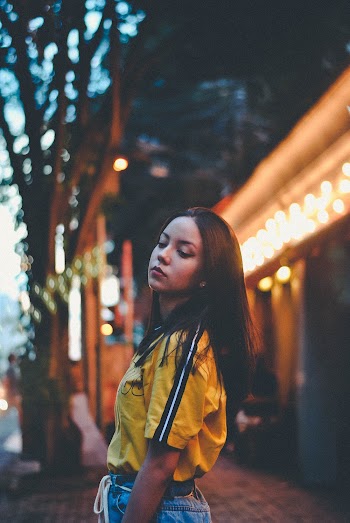 Woman Standing Near Lighted Building