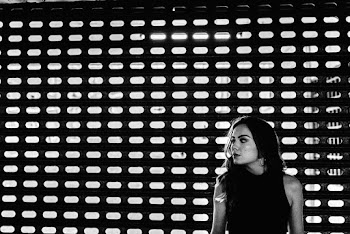 Woman Standing Near Mesh Wall