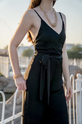 Woman Standing Near Metal Fence