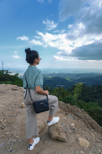 Woman Standing Near Mountain Cliff