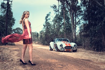 Woman Standing Near Parked Convertible