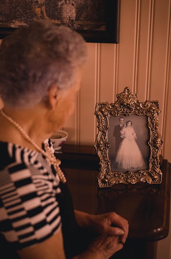Woman Standing Near Photo Frame With Newly Wed Couple Picture