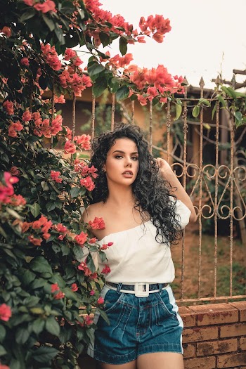 Woman Standing Near Pink Flowers