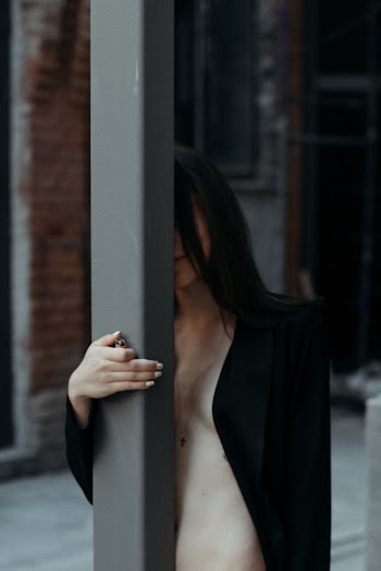 Woman Standing Near Post