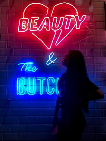 Woman Standing Near Red and Blue Neon Light Signage