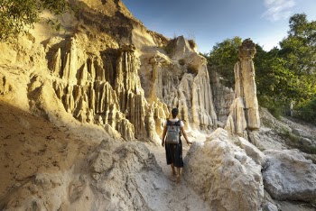 Woman Standing Near Rock Formation