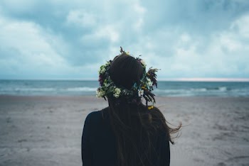 woman standing near seashore during daytime