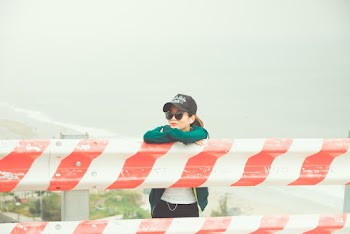 Woman Standing Near Steel Barriers