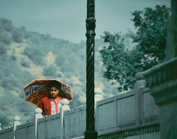 Woman Standing Near Stone Fence