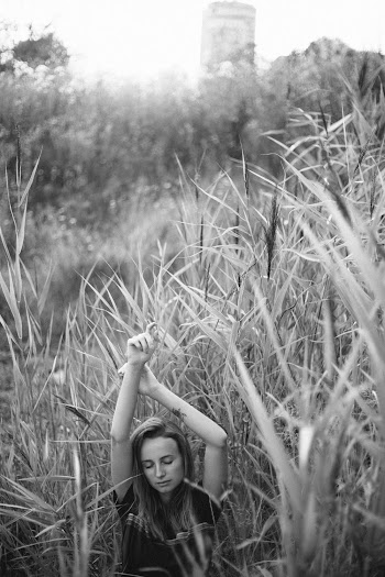 Woman Standing Near Tall Grass