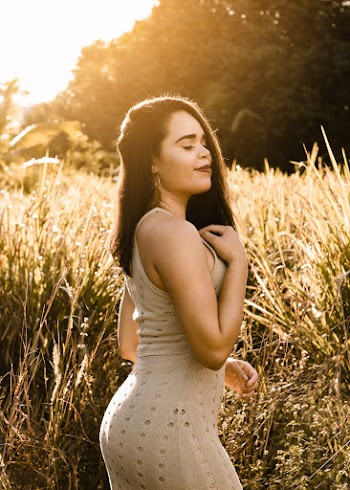 Woman Standing Near Tall Grasses