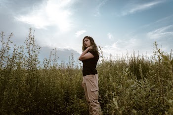Woman Standing Near Tall Grasses