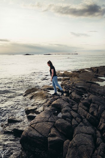 Woman Standing Near the Body of Water