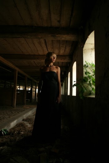 Woman Standing Near the Window Inside the Building