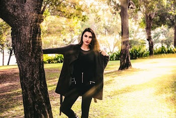 Woman Standing Near Tree Trunk