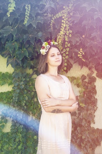 Woman Standing Near Wall With Vines Crawling
