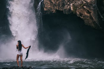 Woman Standing Near Waterfalls