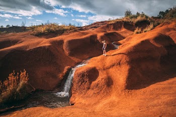 Woman Standing Near Waterfalls