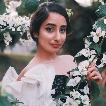 Woman Standing Near White Flowers